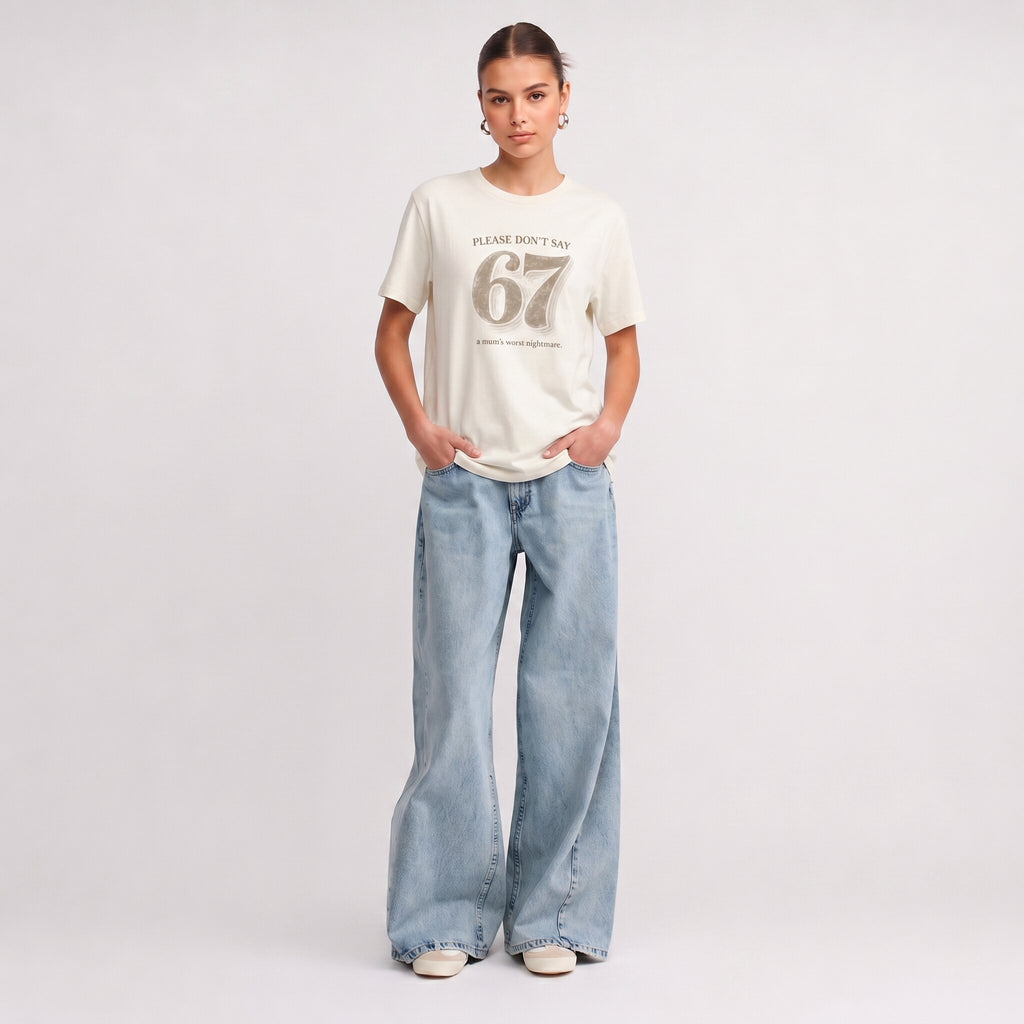 Kiksy cream funny mum t-shirt featuring the slogan Please don't say 67 a mum's worst nightmare, modelled by a woman.