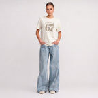Kiksy cream funny mum t-shirt featuring the slogan Please don't say 67 a mum's worst nightmare, modelled by a woman.