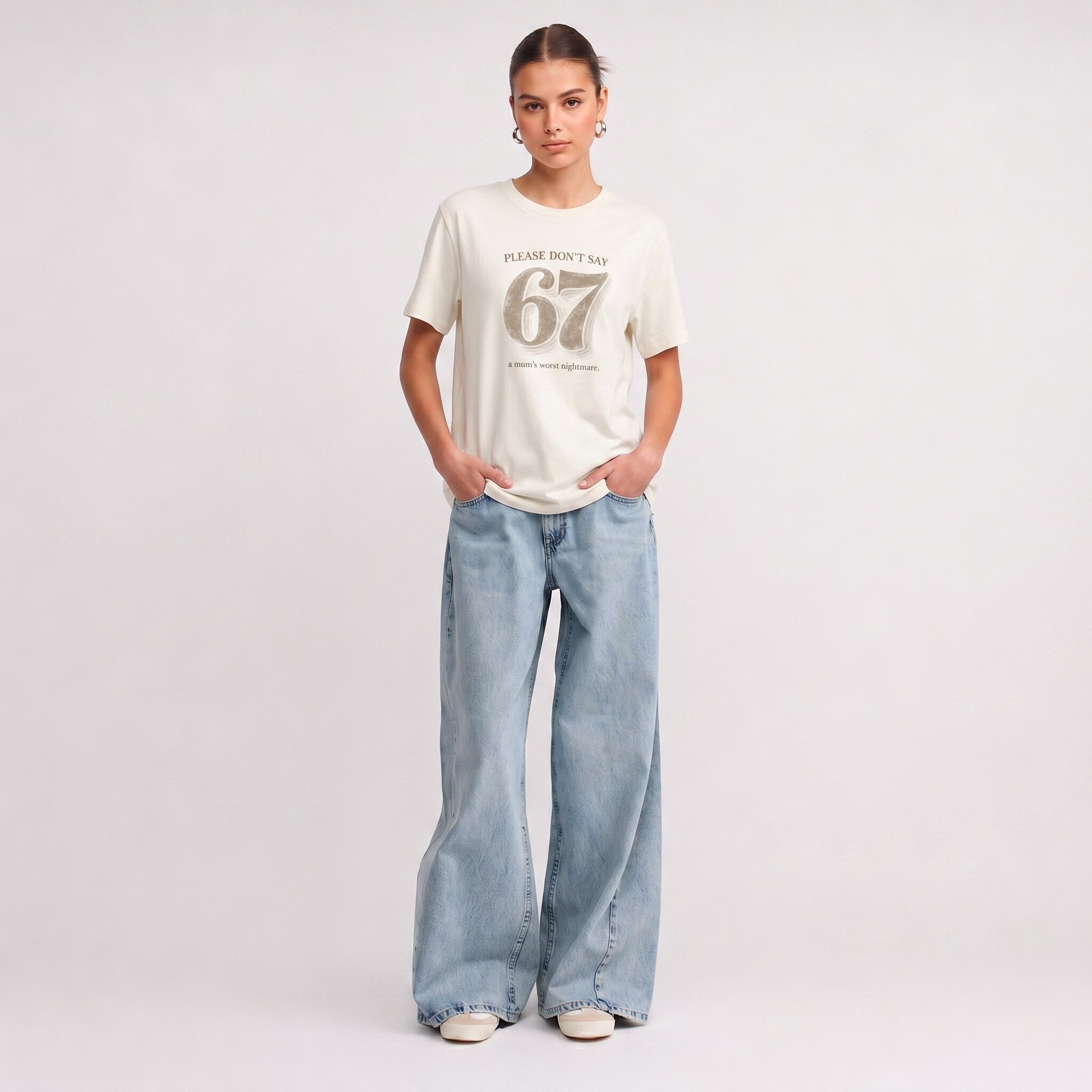 Kiksy cream funny mum t-shirt featuring the slogan Please don't say 67 a mum's worst nightmare, modelled by a woman.