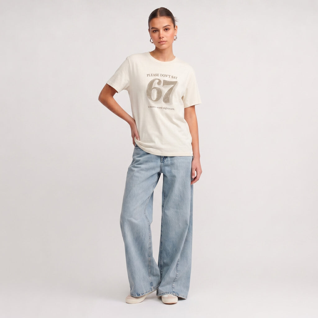 Kiksy cream funny mum t-shirt featuring the slogan Please don't say 67 a mum's worst nightmare, modelled by a woman.