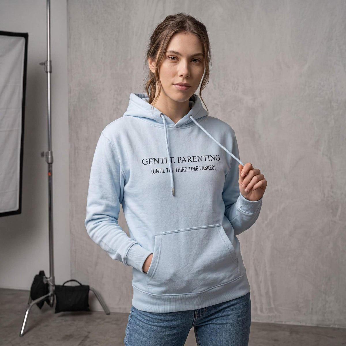 Kiksy sky blue organic cotton hoodie for women featuring gentle parenting slogan printed on front.