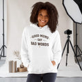 Kiksy white hoodie with Good Mums Say Bad Words printed on the front worn by a smiling woman