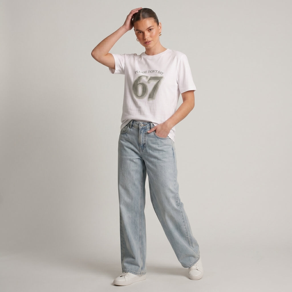 Woman wearing Kiksy white relaxed slogan t-shirt featuring Please Don't Say 67 print with casual blue jeans.